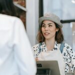 a woman at a counter talking to a customer