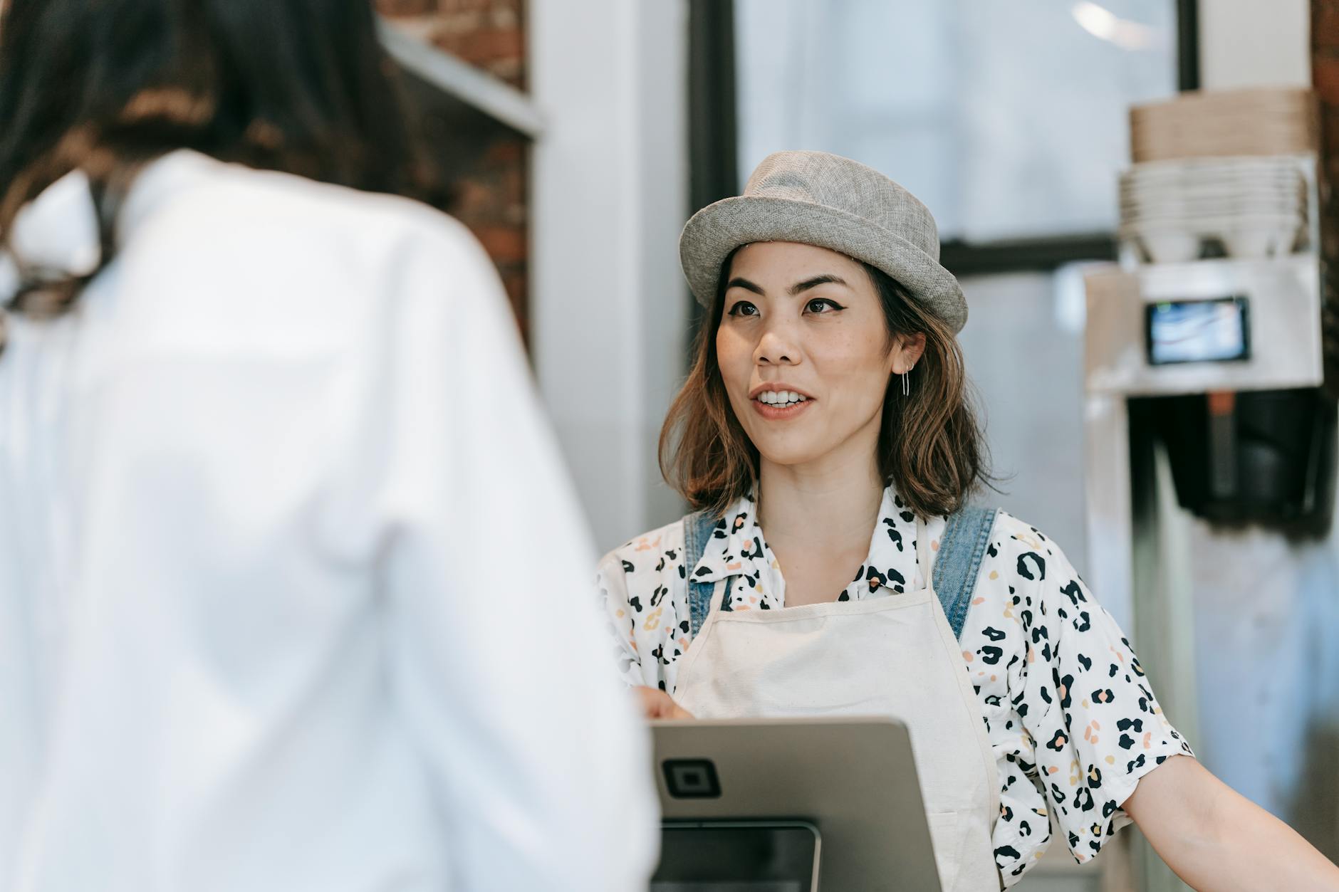 a woman at a counter talking to a customer