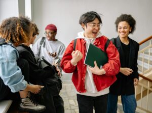 group of students talking at a staircase