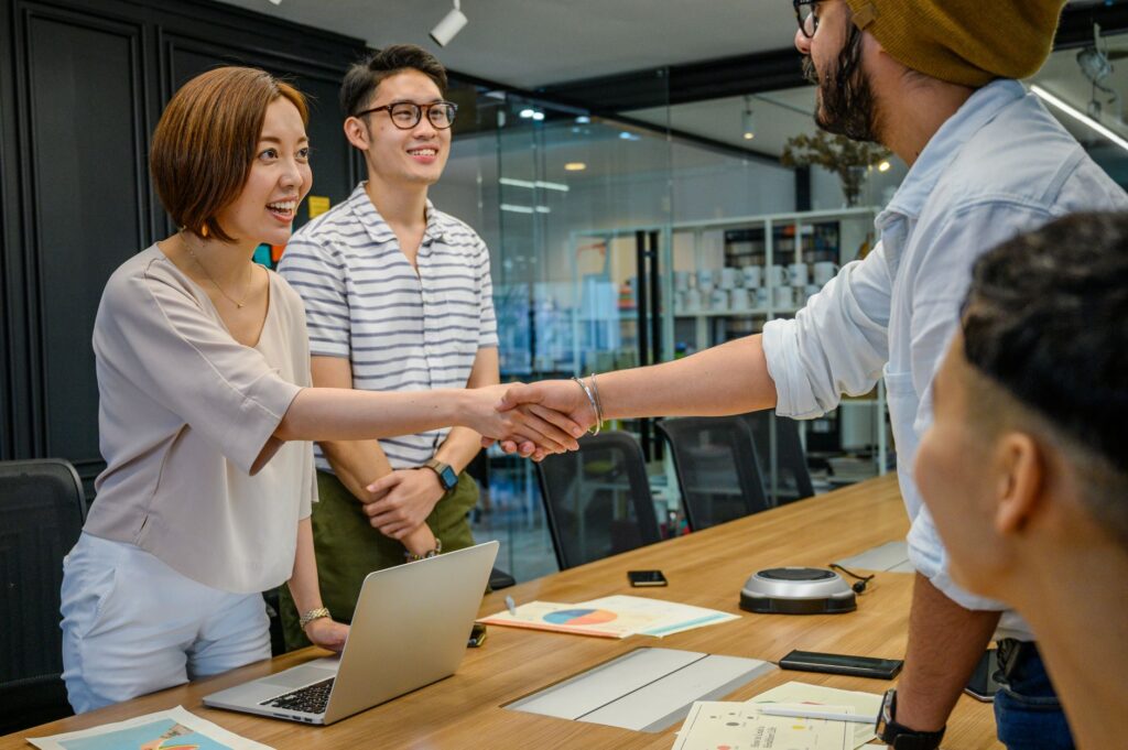 business people shaking hands in office